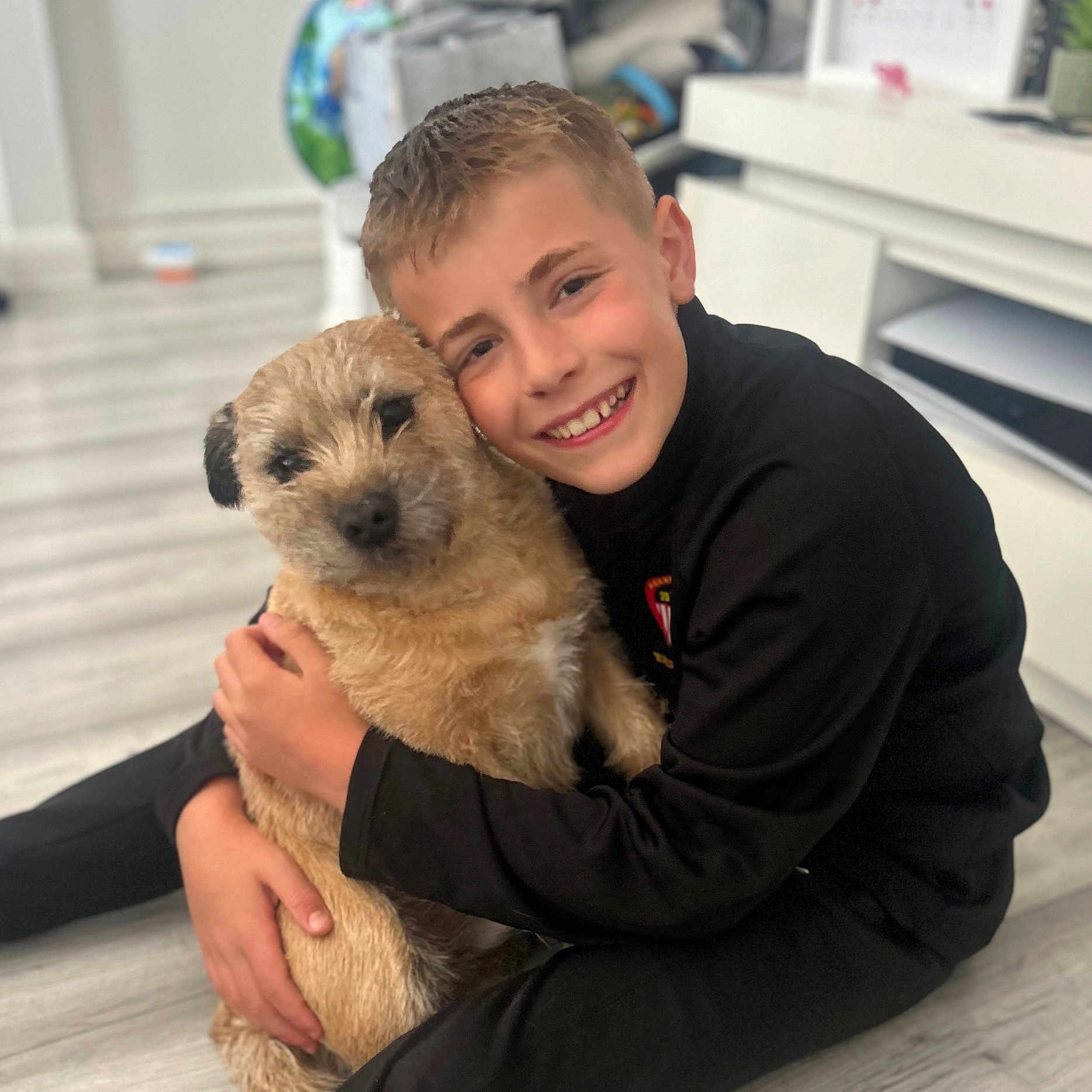 Callum is registered to the contest to win money with this photo: animal, boy, canine, child, clothing, coat, doctor, dog, face, happy, head, jacket, male, person, pet, photography, portrait, puppy, sitting, smile