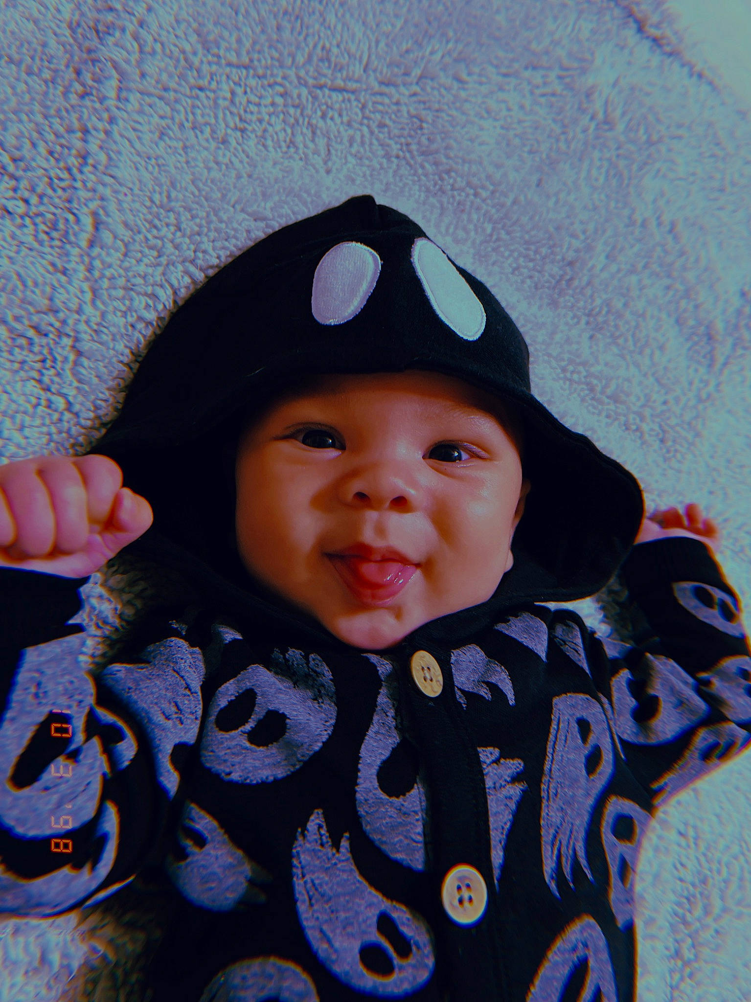 Legend is registered to the contest to win money with this photo: baby, baby_toddler_clothing, cap, cheek, child, electric_blue, eye, face, happy, head, headgear, headwear, knit_cap, lip, outerwear, pattern, person, skin, sleeve, smile