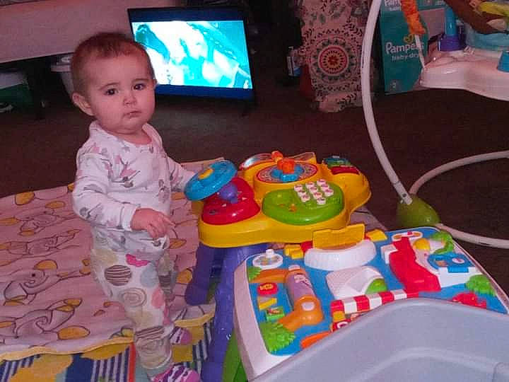 Amiah is registered to the contest to win money with this photo: baby, baby_products, baby_toddler_clothing, baby_toys, child, display_device, event, fun, leisure, output_device, person, pink, plastic, play, recreation, room, sitting, television, toddler, toy