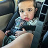 baby, car_interior, car_seat, child, clothing, hair, hand, head, person, safety, seat, seat_belt, serious_face, shorts, sitting, toddler, toy_story, vehicle, window, young_child