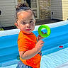 backyard, blue_shorts, brick_wall, child, daytime, door, fun, green_ring, inflatable_pool, orange_shirt, outdoor, person, play, pool, summer, sunny, toddler, toy, water, young_child