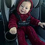 baby, child, car_seat, red_onesie, hoodie, smiling, seatbelt, cup_holder, car_interior, safety, infant, happy, portrait, cozy, clothing, person, baby_fashion, seated, cute, transportation
