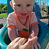 baby, blue, child, clothing, cute, daylight, grass, hand, happy, infant, orange, outdoor, person, play_equipment, playground, sky, smile, sunlight, swing, trees