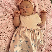 Skyla is registered to the contest to win money with this photo: baby, sleeping, pink, headband, bow, blanket, knitted, cute, infant, child, soft, clothing, pattern, peaceful, resting, small, hands, feet, white_socks, portrait