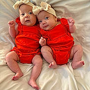 Selah And Alujah joined the competition — help win amazing prizes! baby, infant, twin, headband, bow, orange_clothing, blanket, bed, lying_down, cute, newborn, child, person, skin, smile, happy, indoors, portrait, small_fingers, soft_texture