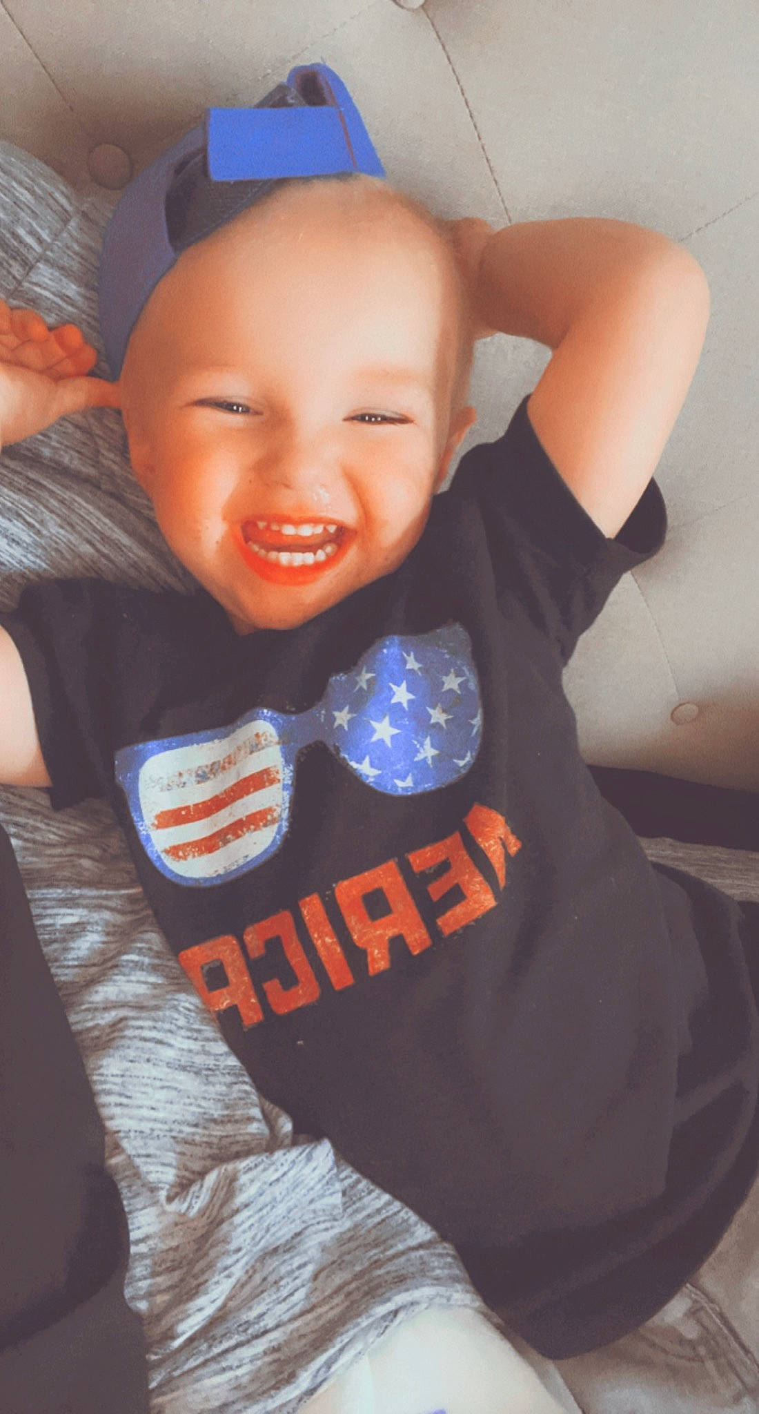 Brayson is registered to the contest to win money with this photo: azure, baby_toddler_clothing, cheek, cool, eye, eyebrow, facial_expression, finger, gesture, happy, headgear, human_body, joint, mouth, neck, orange, person, sleeve, smile, t_shirt