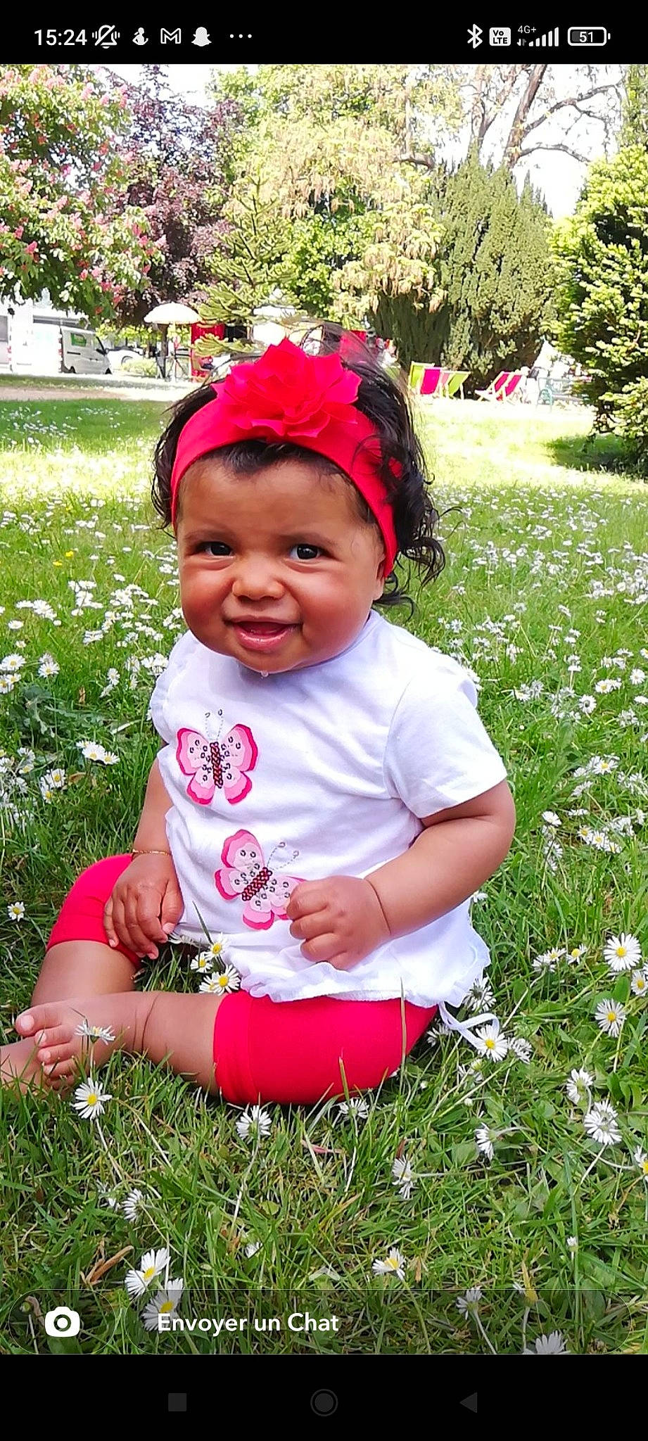 Inaya a rejoint le concours — aidez-le/la à gagner de superbes lots ! baby, baby_toddler_clothing, botany, child, facial_expression, flower, fun, grass, green, groundcover, happy, lawn, magenta, people_in_nature, person, petal, pink, plant, smile, toddler