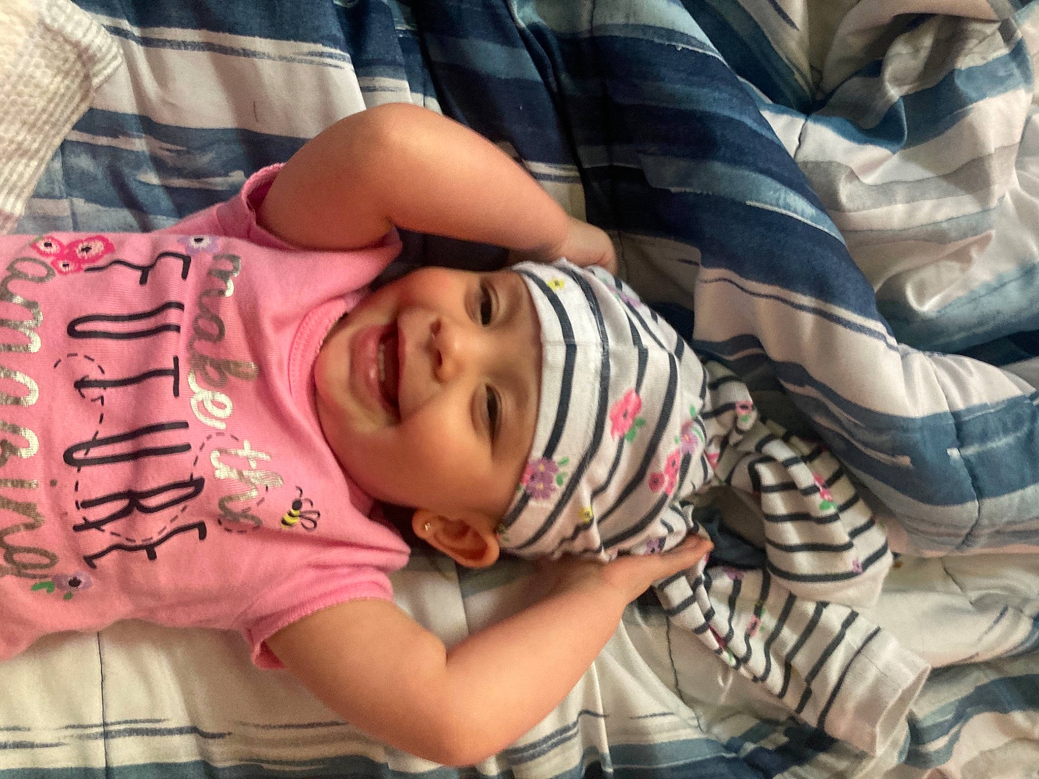 Jaylee is registered to the contest to win money with this photo: arm, baby, baby_toddler_clothing, cheek, child, comfort, fun, happy, hat, headwear, human, human_leg, joy, mouth, pattern, person, pink, skin, smile, t_shirt