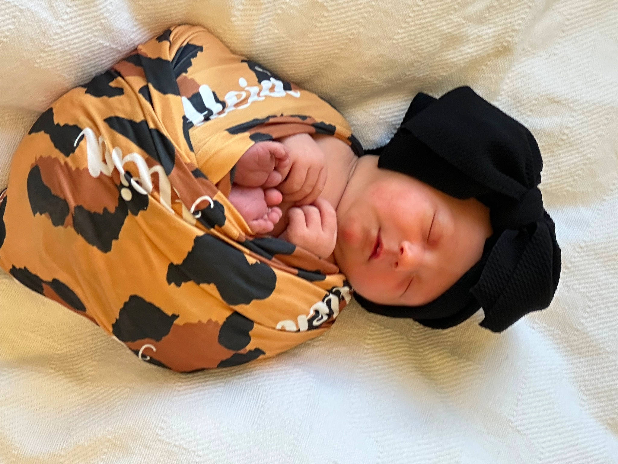 Aleia is registered to the contest to win money with this photo: abdomen, baby, baby_sleeping, baby_toddler_clothing, bedding, child, comfort, elbow, fashion_accessory, flooring, headwear, human_body, linens, military_camouflage, nap, pattern, person, sleep, sleeve, sunglasses