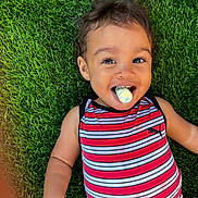 Ourlo is registered to the contest to win money with this photo: toddler, child, grass, outdoor, striped_clothing, smiling, happy, face, portrait, casual, playful, chalk, colorful, cute, young_child, summer, nature, relaxed, fun, person