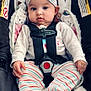 Addison is registered to the contest to win money with this photo: baby, infant, car_seat, headband, striped_clothing, safety_harness, floral_pattern, cute, child, seat, fabric, person, young, indoors, comfort, small_hands, footed_pajamas, expression, headwear, rest