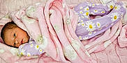 Addison joined the competition — help win amazing prizes! baby, blanket, pink, purple, pajamas, daisies, floral_pattern, sheep_pattern, infant, sleepwear, soft_texture, quilted, cute, newborn, lying_down, face, person, child, indoors, cozy