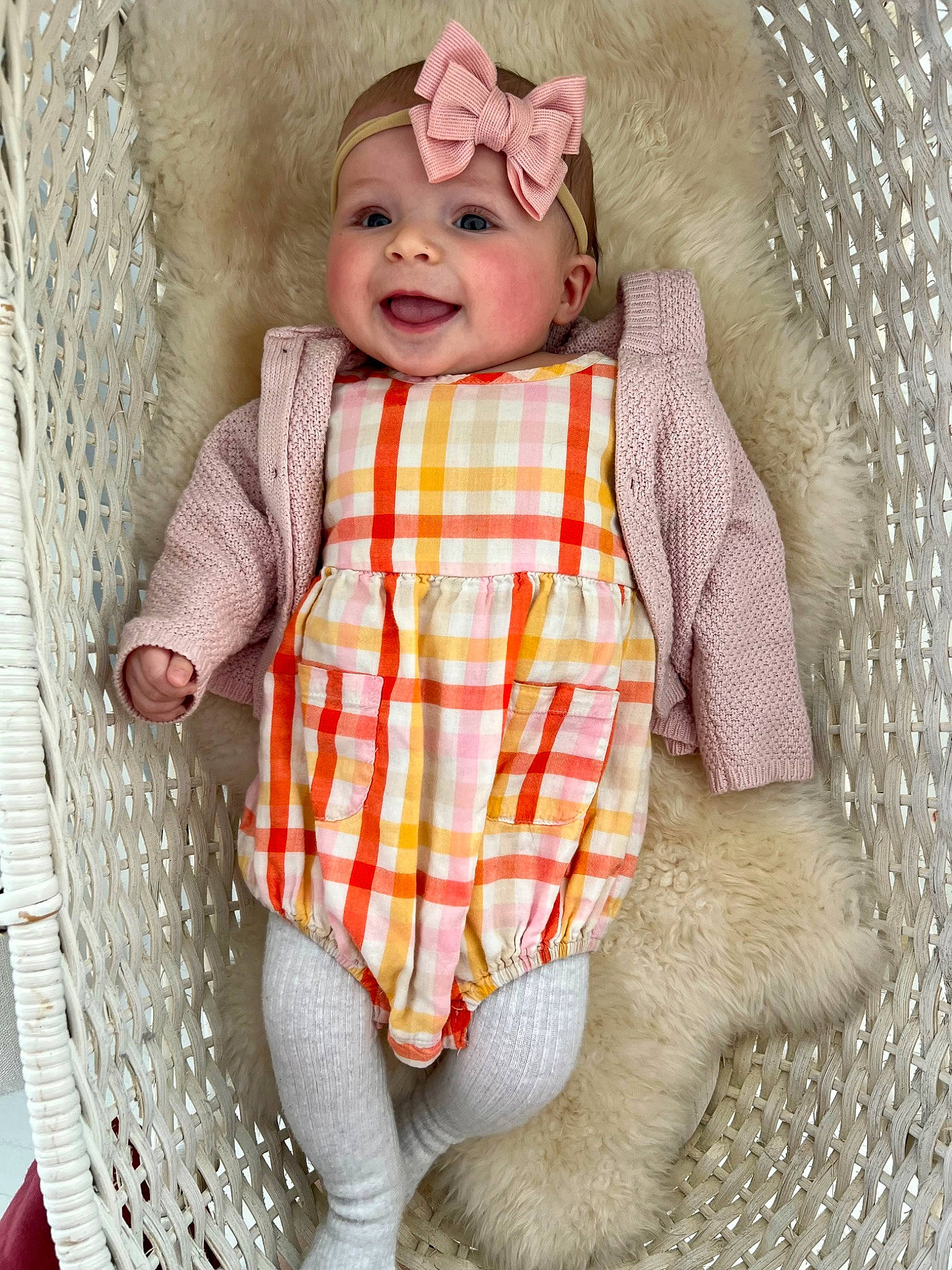 Ella joined the competition — help win amazing prizes! baby, baby_products, baby_toddler_clothing, child, dress, eye, face, happy, head, headwear, linens, outerwear, pattern, peach, person, plaid, sitting, skin, sleeve, smile