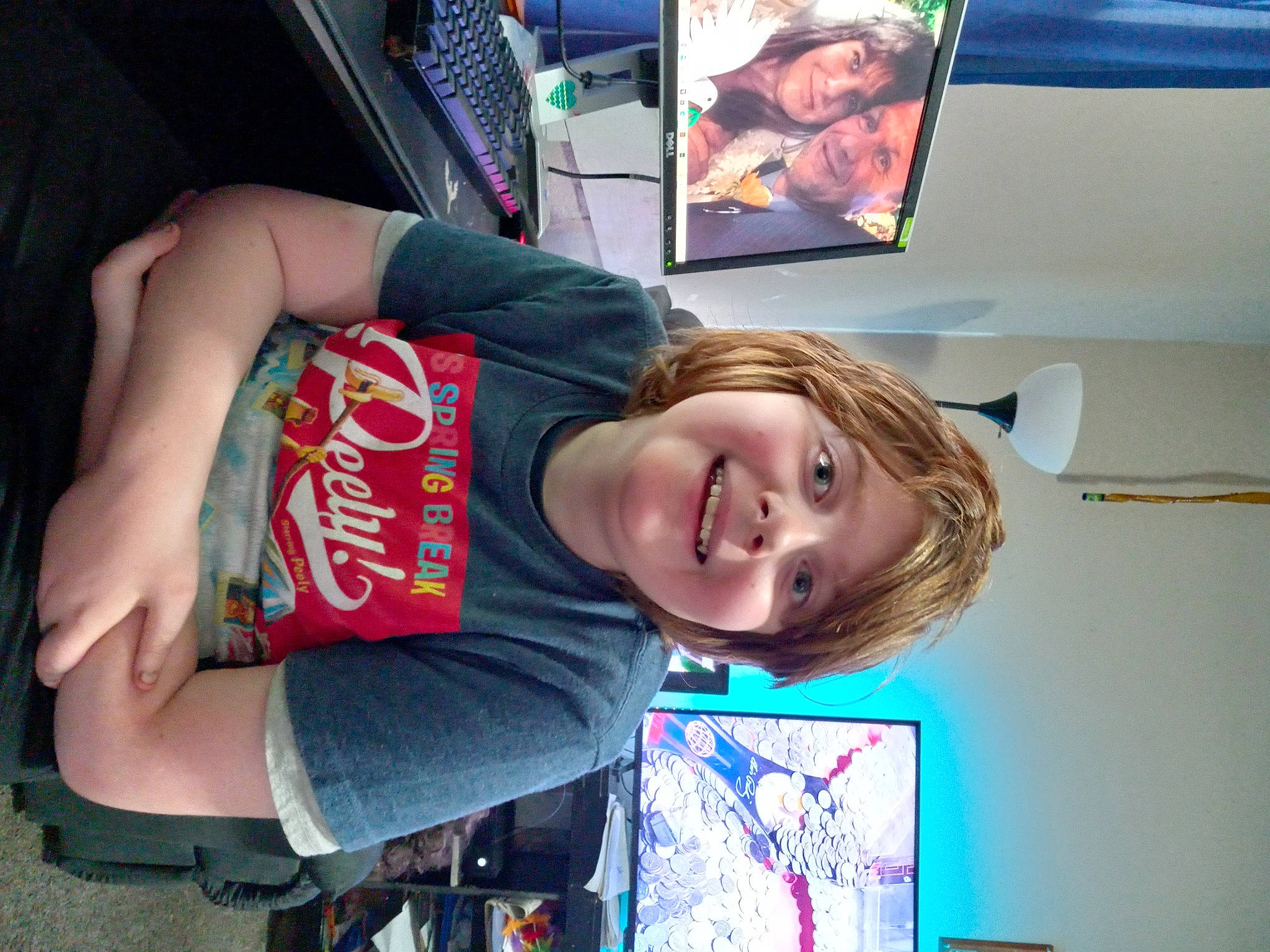 Shaun is registered to the contest to win money with this photo: art, automotive_exterior, child, display_device, elbow, family_car, fun, happy, headwear, joy, laugh, leisure, person, recreation, room, smile, snapshot, t_shirt, television, television_set