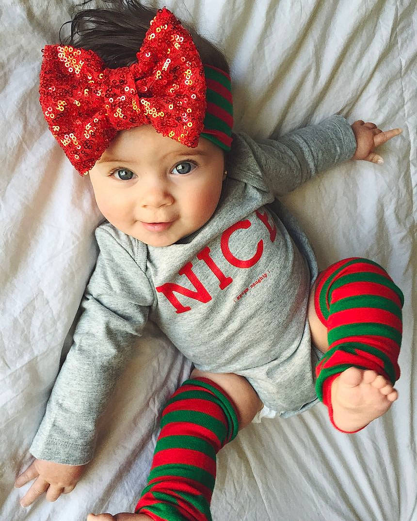 Elizabeth is registered to the contest to win money with this photo: baby, baby_products, baby_toddler_clothing, bonnet, child, child_model, costume, costume_accessory, costume_hat, embellishment, headband, headgear, headwear, pattern, person, red, sock, stuffed_toy, textile, toddler