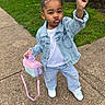 Legacy is registered to the contest to win money with this photo: child, denim_jacket, jeans, sidewalk, grass, brick_wall, purse, fuzzy, pink, purple, white_shirt, sneakers, posing, outdoor, playful, cute, smiling, person, fashion, young