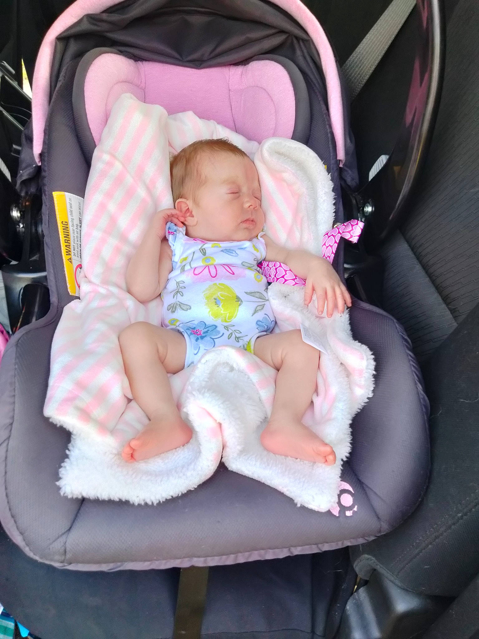Sarah is registered to the contest to win money with this photo: baby, baby_carriage, baby_products, baby_toddler_clothing, beauty, car_seat, child, comfort, eye, fun, human_body, lap, leg, people, person, pink, product, sitting, skin, toddler