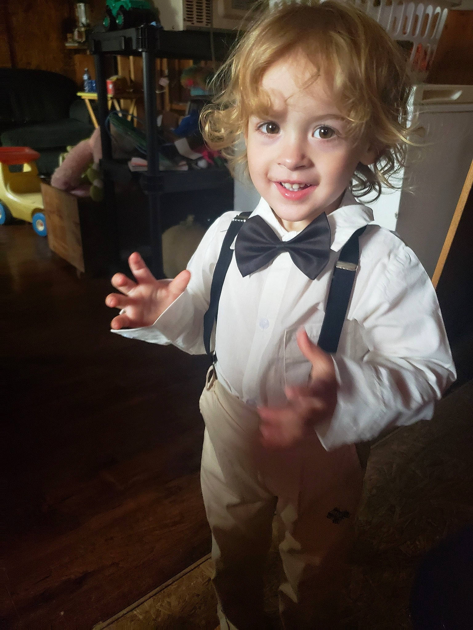 Clarke joined the competition — help win amazing prizes! blond, bow_tie, chair, child, dress_shirt, event, flash_photography, flooring, formal_wear, fun, gesture, happy, joy, person, sitting, smile, suit, tie, toddler, tuxedo