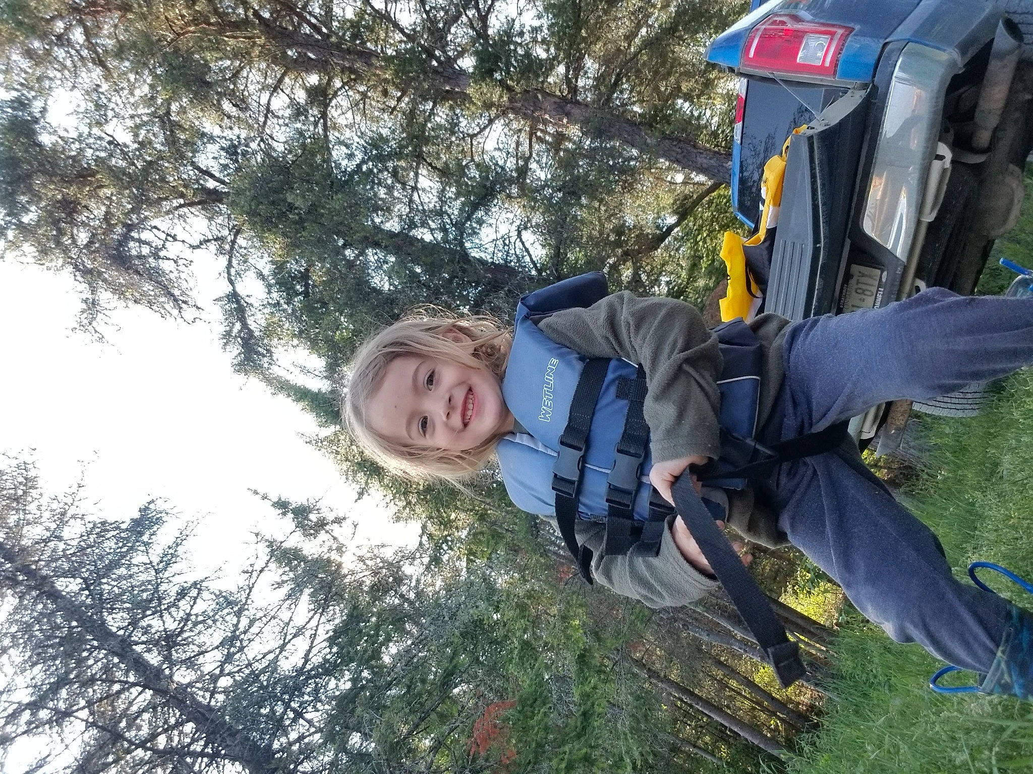 Clarke is registered to the contest to win money with this photo: adventure, air_sports, backpack, backpacking, bag, fun, grass, happy, joy, leaf, leisure, luggage_and_bags, parachuting, people_in_nature, person, plant, recreation, sky, smile, travel