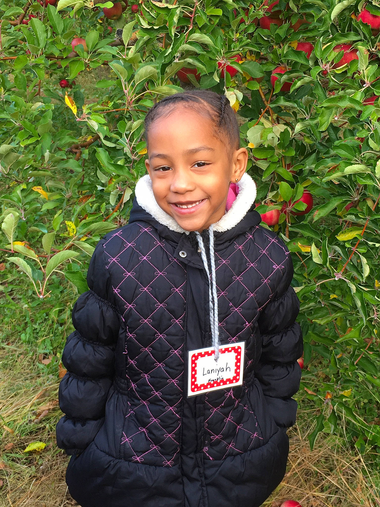 Laniyah joined the competition — help win amazing prizes! annual_plant, botany, eye, facial_expression, flower, flowering_plant, grass, happy, head, jacket, joy, leaf, pattern, people_in_nature, person, plant, sleeve, smile, standing, toddler