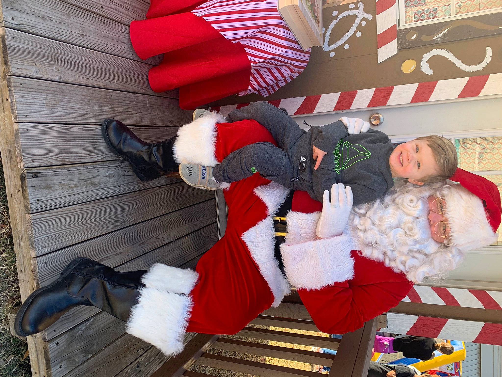 Mason is registered to the contest to win money with this photo: carmine, christmas, christmas_eve, comfort, costume, event, fictional_character, fun, holiday, human_leg, joy, lap, leg, leisure, pattern, person, red, santa_claus, shoe, thigh