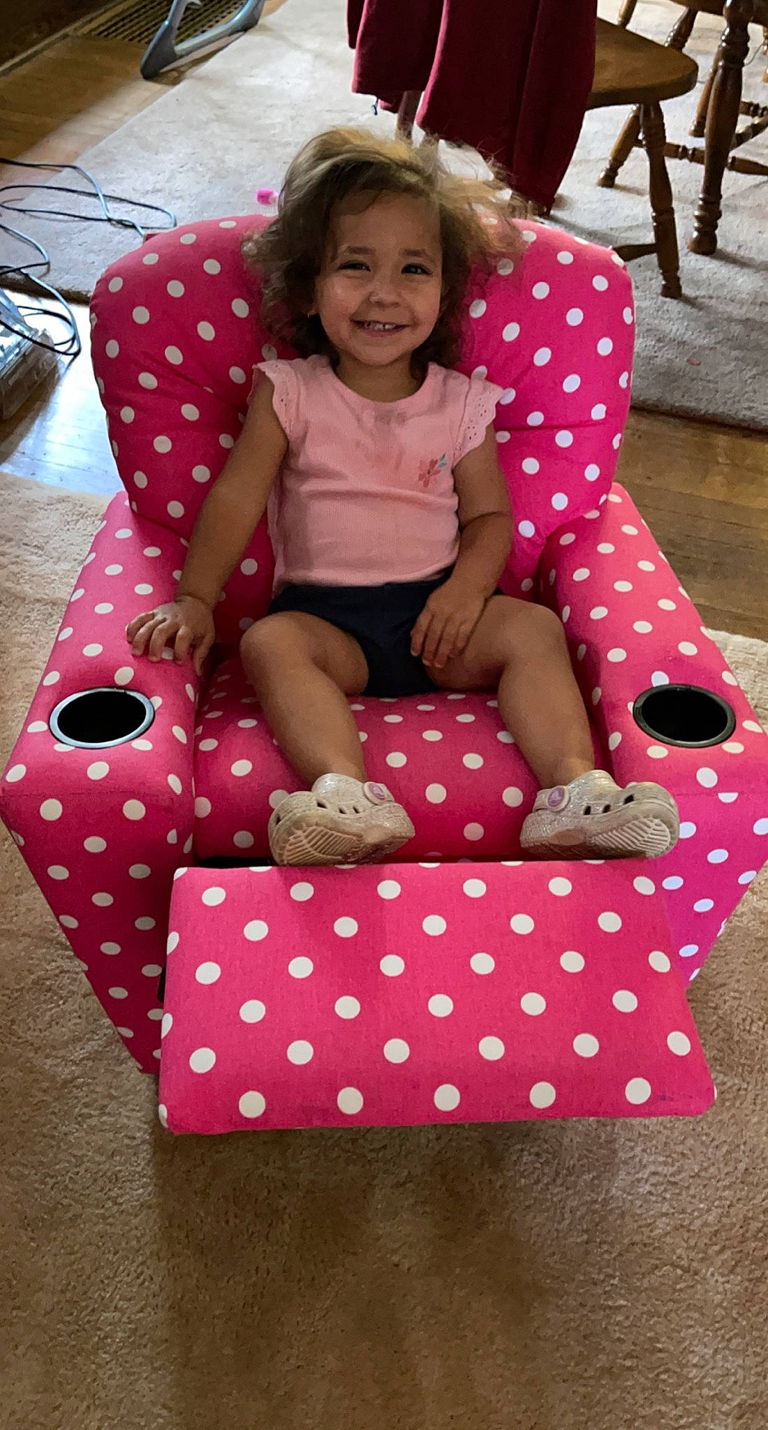 Ailah is registered to the contest to win money with this photo: baby_toddler_clothing, chair, child, design, dress, fun, happy, human_leg, joy, lap, leisure, magenta, pattern, person, pink, sitting, smile, sock, textile, thigh