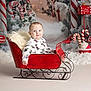 baby, child, red_sleigh, christmas_decorations, candy_canes, peppermint_lollipops, snow, pine_trees, holiday, festive, mickey_mouse_outfit, smiling, indoor, portrait, seasonal, cute, holiday_theme, winter, happy, decor