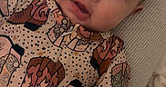 Mylan is registered to the contest to win money with this photo: baby, blanket, child, clothing, cute, expression, eyes, face, hand, head, indoor, infant, lying_down, patterned_outfit, person, portrait, skin, soft_light, toddler, young