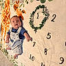 Aiden joined the competition — help win amazing prizes! age_marker, baby, blanket, blue_shirt, child, cute, floor, giraffe, happy, home, infant, leaf, lying_down, numbers, overalls, portrait, smiling, soft_light, wreath, young