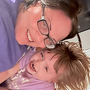 Addilynn is registered to the contest to win money with this photo: adult, casual, child, face, family, glasses, hair, happy, human, indoor, lock_screen, notification_icons, phone_ui, playful, portrait, purple_clothing, skin, smiling, tattoo, time_display