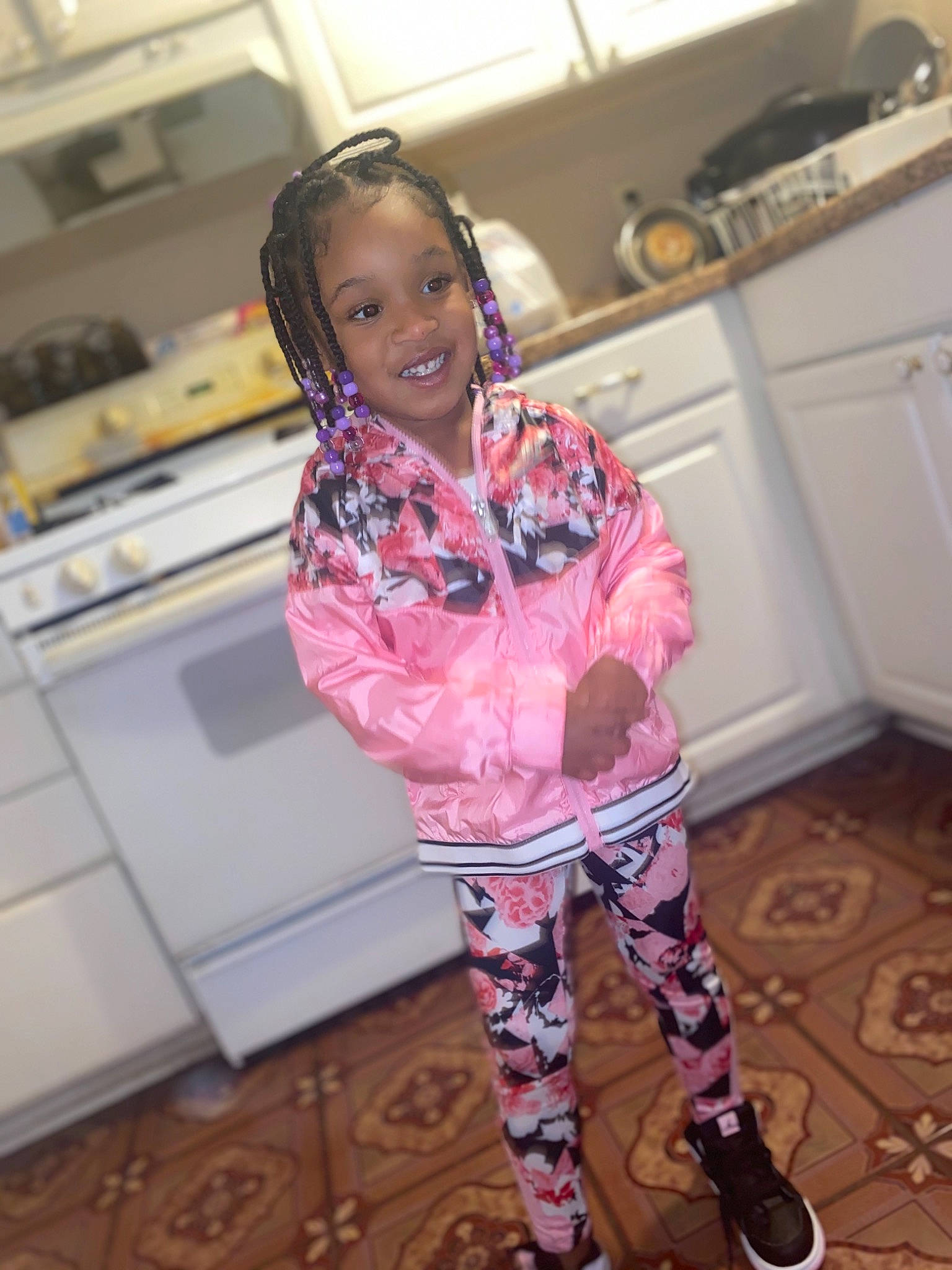 Maliyah is registered to the contest to win money with this photo: baby_toddler_clothing, cabinetry, countertop, fashion_accessory, fashion_design, flooring, happy, home_appliance, joy, kitchen, kitchen_appliance, leg, magenta, person, personal_protective_equipment, purple, room, sleeve, smile, standing