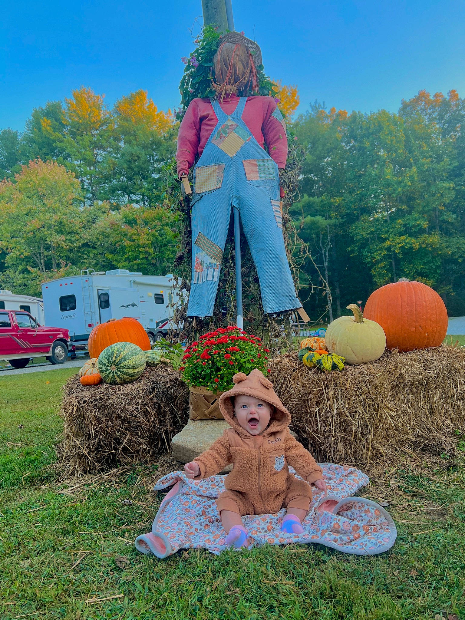 Wren is registered to the contest to win money with this photo: art, fun, grass, grassland, happy, headwear, landscape, lawn, lawn_ornament, leisure, meadow, people_in_nature, person, plant, pumpkin, recreation, sculpture, sky, summer, tire