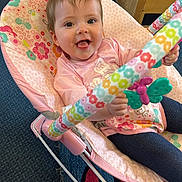 Isabella joined the competition — help win amazing prizes! baby, child, pink, rocker, toy, butterfly, smiling, indoor, carpet, clothing, person, furniture, floor, happy, seat, play, colorful, cute, infant, holding