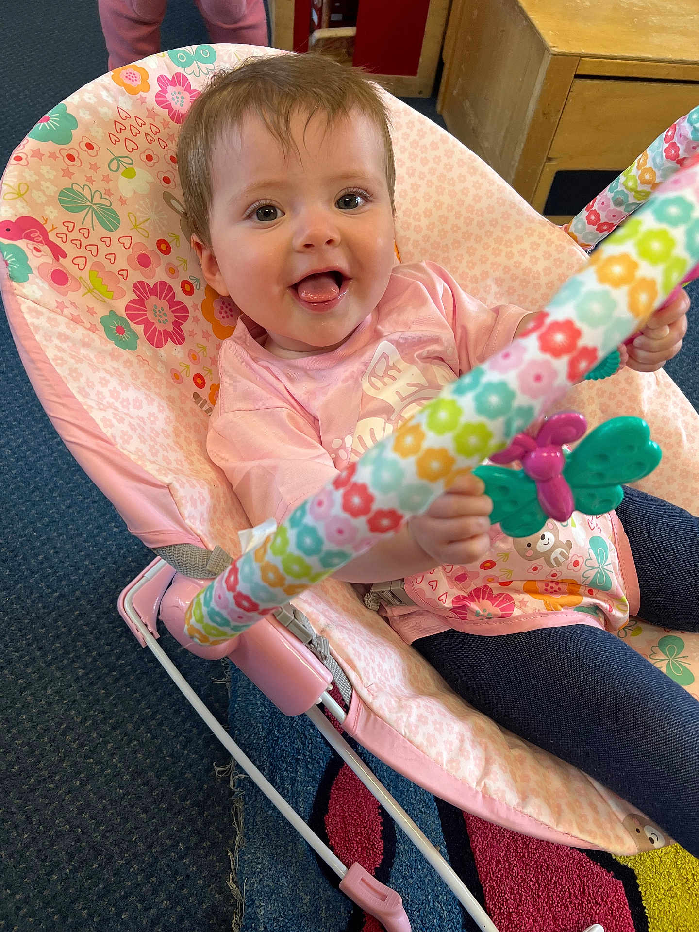 Isabella joined the competition — help win amazing prizes! baby, child, pink, rocker, toy, butterfly, smiling, indoor, carpet, clothing, person, furniture, floor, happy, seat, play, colorful, cute, infant, holding