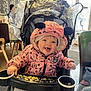 Isabella is registered to the contest to win money with this photo: baby, bow, cafe, child, clothing, crumbs, cute, face, food, happy, high_chair, hood, indoor, minnie_mouse, person, pink_jacket, seat, smile, stroller, warm_clothing
