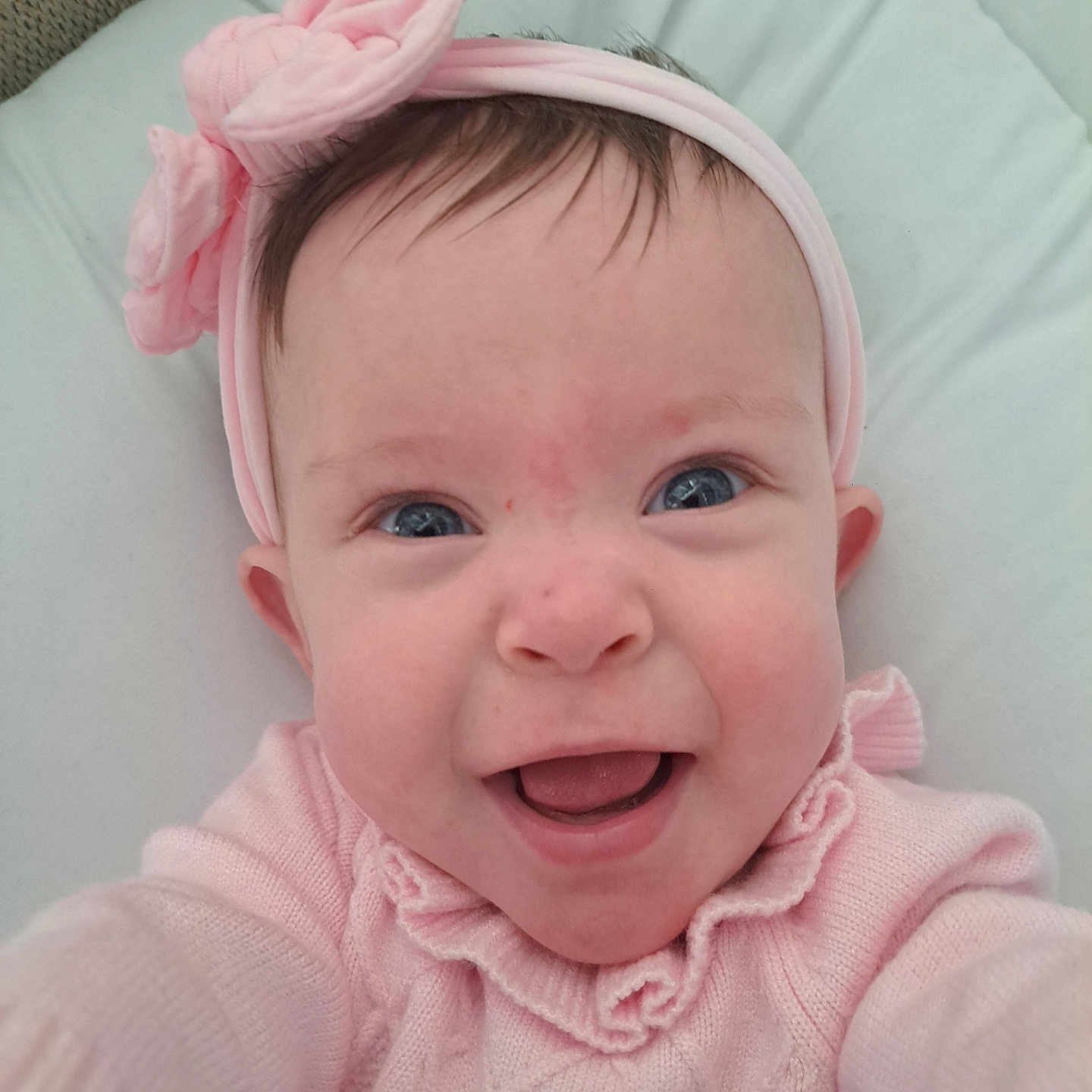 Evie-May is registered to the contest to win money with this photo: accessories, baby, bonnet, clothing, face, flower, happy, hat, head, headband, knitwear, laughing, newborn, person, photography, plant, portrait, rose, smile, sweater