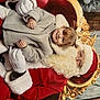 Kessy participe au concours pour gagner de l'argent avec cette photo : child, smiling, santa_claus, holiday, christmas, coat, gloves, beard, red_clothing, gold_chair, festive, tree, decorations, indoor, portrait, happy, person, seasonal, celebration, winter