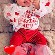 Rosalise is registered to the contest to win money with this photo: adorable, baby, child, cozy_blanket, cute, cute_baby, festive, happy, heart_pattern, holiday_outfit, infant, portrait, red_clothing, sitting, smiling, tongue_out, tulle_pants, tulle_sleeves, valentines_day, white_socks