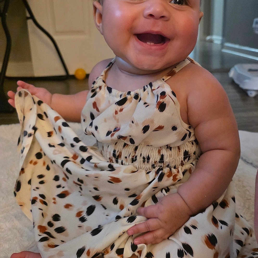 Rosalise joined the competition — help win amazing prizes! baby, bright, child, clothing, cute, door, dress, face, feet, floor, hands, happy, home, indoors, infant, joyful, playful, rug, sitting, smiling