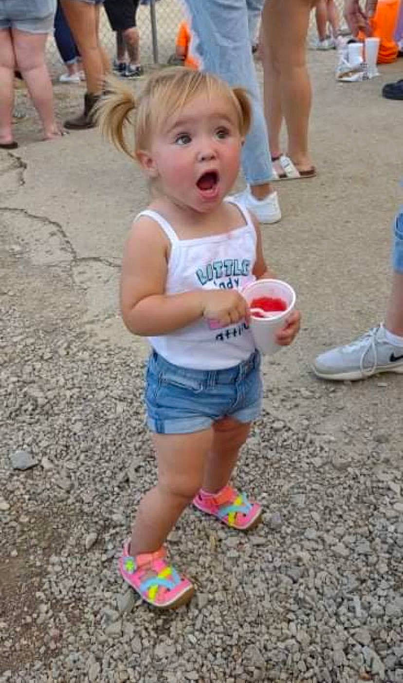 Emma Grace is registered to the contest to win money with this photo: calf, child, event, fun, hairstyle, human_leg, leg, leisure, person, photograph, pink, recreation, shoe, shorts, snapshot, sneakers, surprise, t_shirt, thigh, toddler