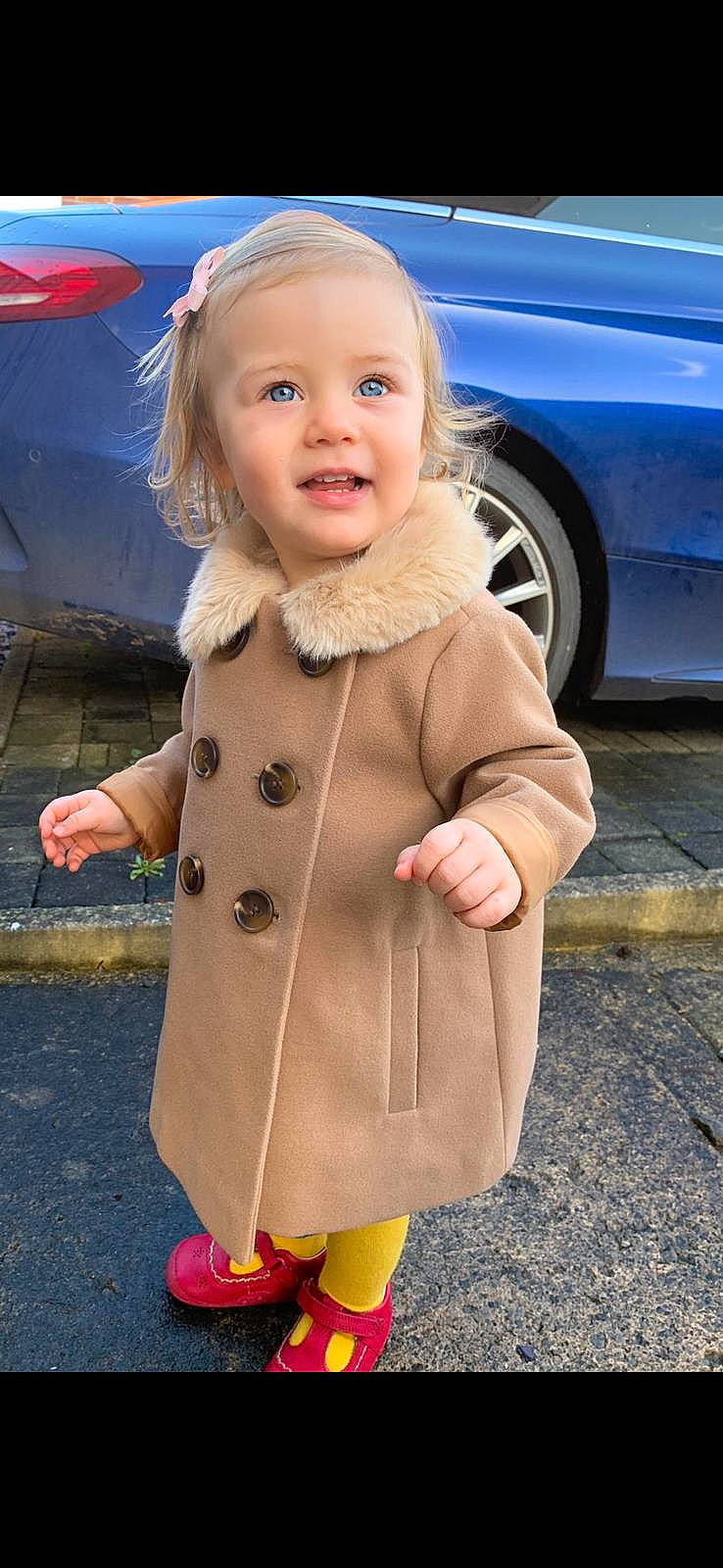 Nyah joined the competition — help win amazing prizes! baby_toddler_clothing, car, dress, face, head, jacket, orange, outerwear, person, photograph, pink, shoe, skin, sleeve, smile, street_fashion, tire, toddler, wheel, white