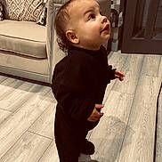 Loui-J is registered to the contest to win money with this photo: black_clothing, child, couch, cozy, curious, face, floor, furniture, hair, home, indoor, looking_up, person, pillow, shoes, smile, standing, toddler, wooden_floor, young_child