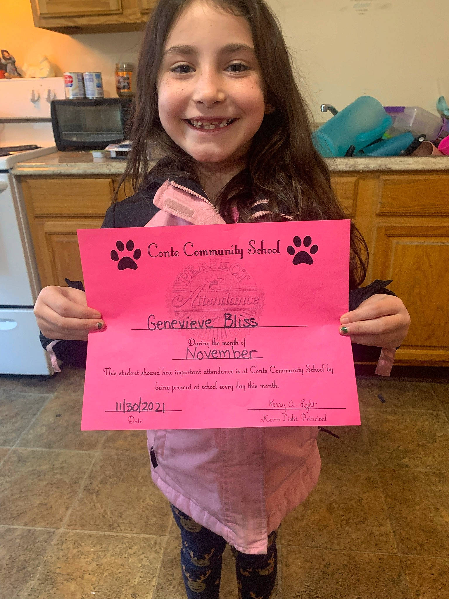 Genevieve joined the competition — help win amazing prizes! academic_institution, cabinetry, child, clothing, dress, event, face, font, fun, handwriting, happy, home_appliance, jeans, joy, kitchen_appliance, person, pink, smile, snapshot, standing
