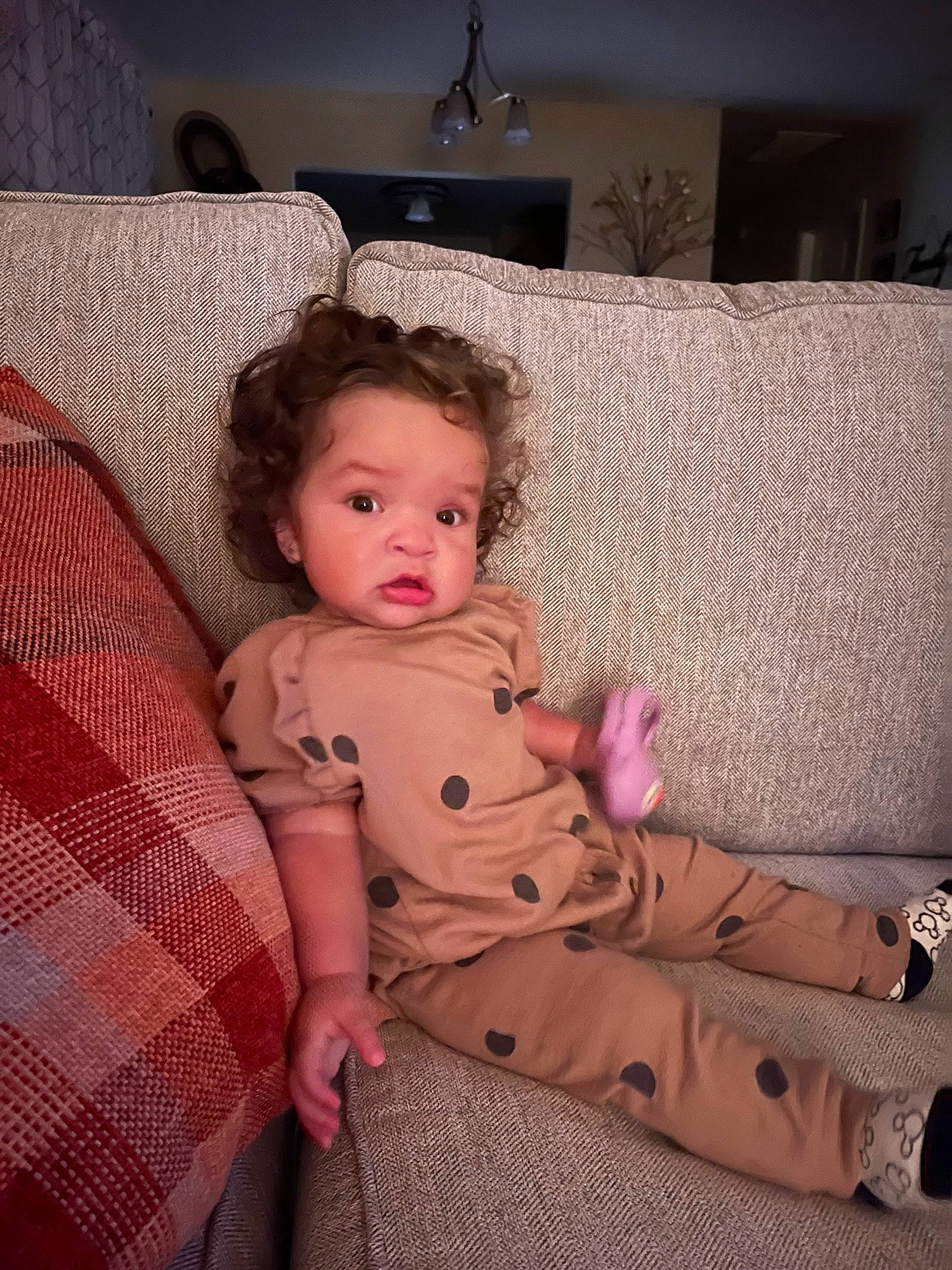 Keziah joined the competition — help win amazing prizes! baby, baby_toddler_clothing, child, comfort, couch, floor, flooring, fun, hardwood, head, human_leg, lap, linens, living_room, person, pink, room, sitting, thigh, toddler