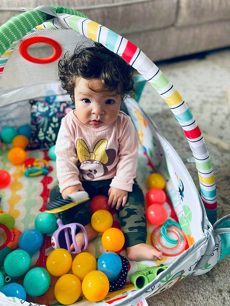 Keziah is registered to the contest to win money with this photo: baby, baby_products, baby_toys, ball, ball_pit, child, confectionery, event, fun, holiday, pattern, people, person, play, product, recreation, room, sitting, sweetness, toddler