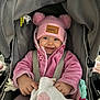 baby, blanket, car_seat, child, clothing, cozy, cute, face, happy, headwear, indoor, infant, person, pink_hat, pink_jacket, pom_poms, seatbelt, smile, toy, warm