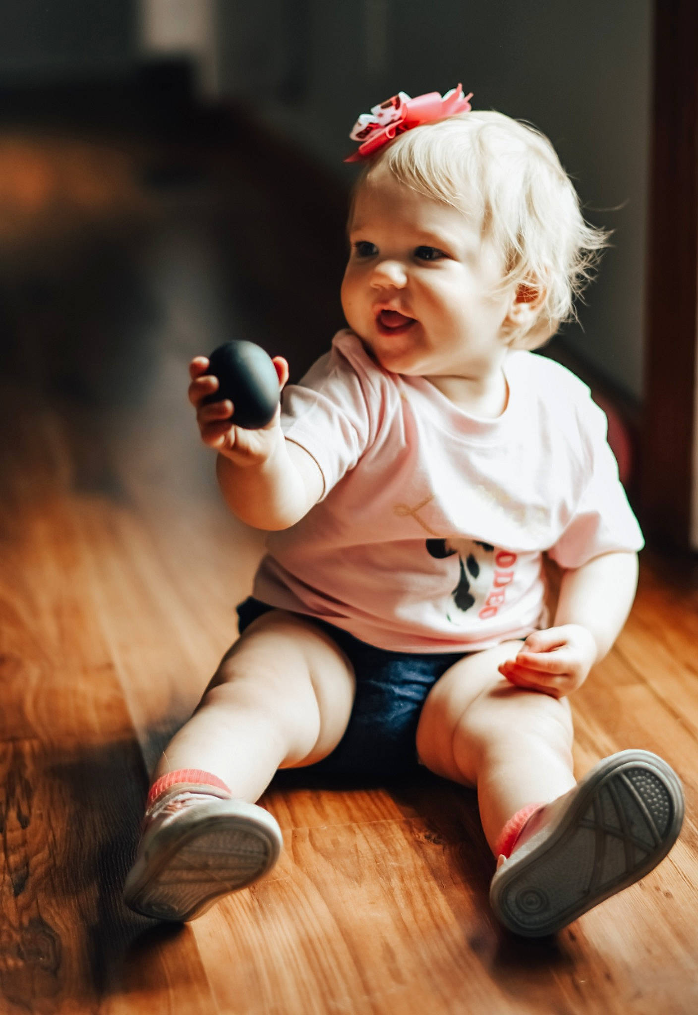 Lettie is registered to the contest to win money with this photo: arm, baby, baby_toddler_clothing, cheek, child, finger, flash_photography, flooring, foot, fun, happy, hardwood, head, human_leg, person, skin, smile, sock, standing, toddler