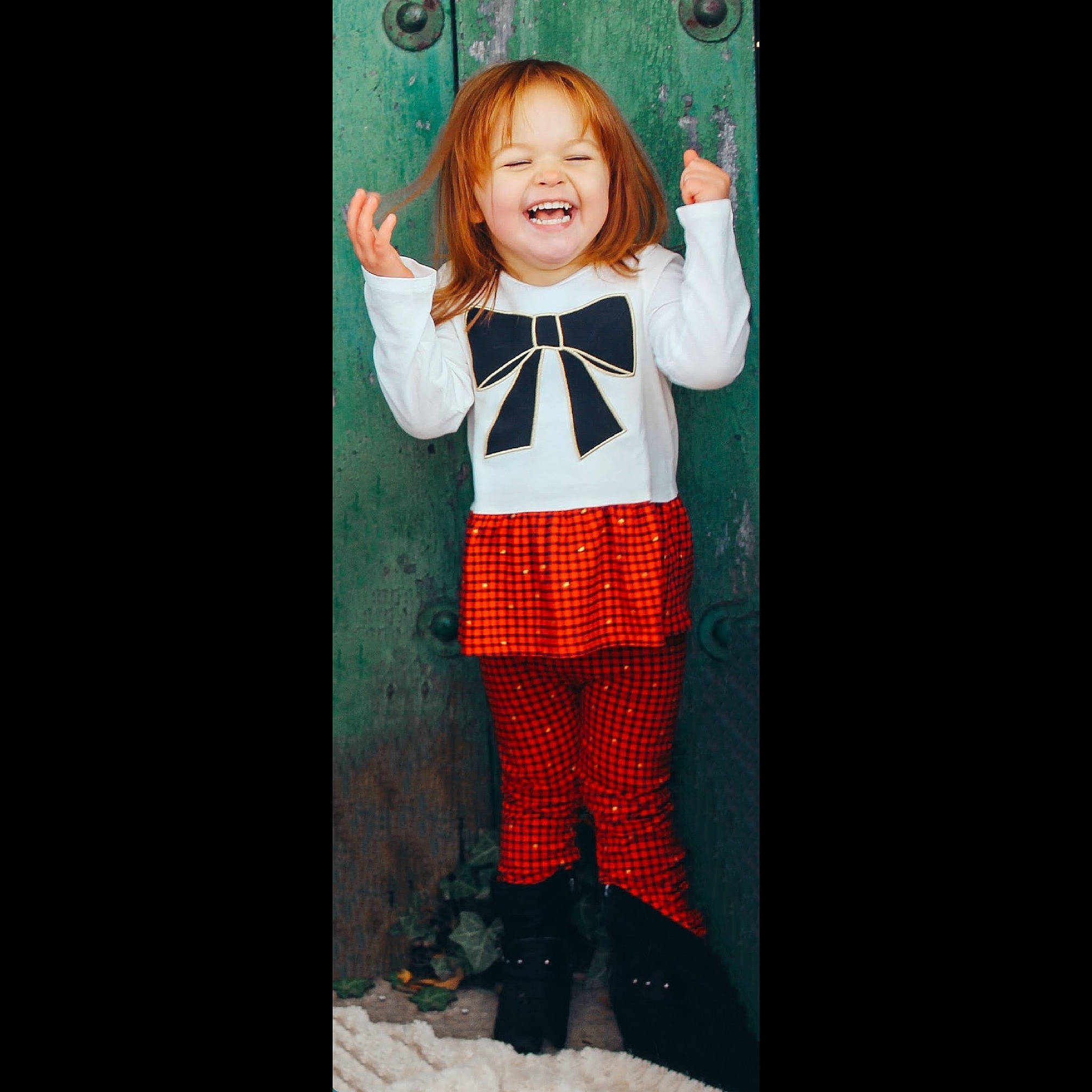 Charlie is registered to the contest to win money with this photo: child, child_model, clothing, cool, costume, design, fashion, joy, orange, outerwear, pattern, person, sleeve, smile, snapshot, standing, sweater, t_shirt, tights, toddler