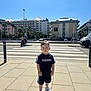 child, boy, sidewalk, adidas, sportswear, sneakers, urban, crosswalk, daylight, buildings, palm_trees, street, shadow, outdoor, casual, shorts, tshirt, person, sky, photography