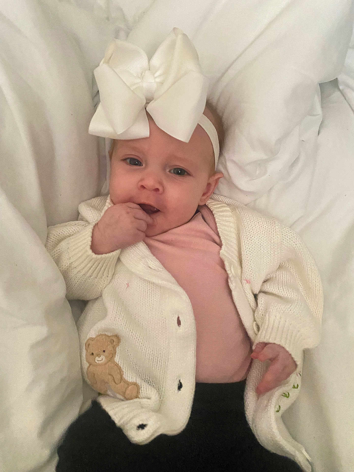 Wrainy joined the competition — help win amazing prizes! baby, black_pants, blanket, cardigan, child, cozy, cute, expression, face, hand, headband, indoors, infant, lying_down, pink_shirt, portrait, small_child, soft_texture, teddy_bear_patch, white_bow